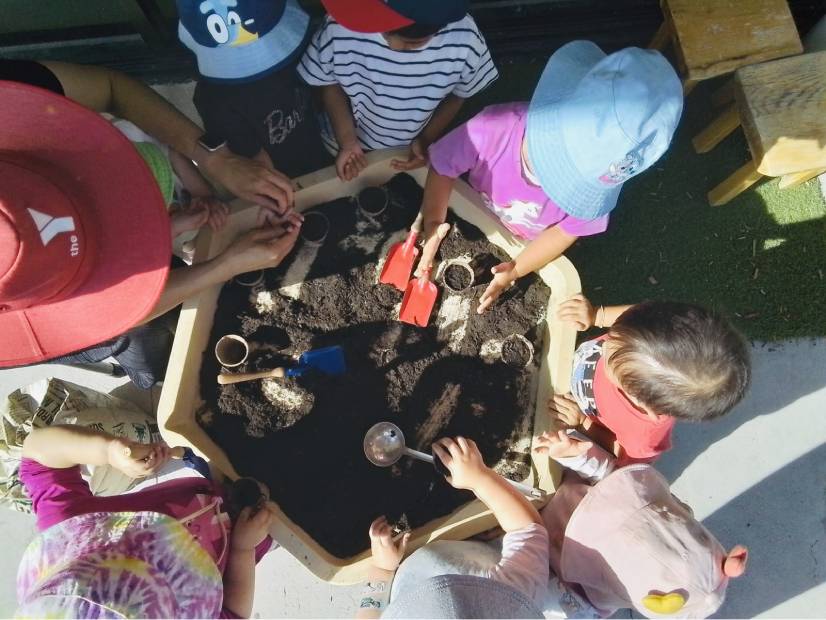 Children and staff playing in small garden